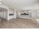Open-concept kitchen boasts stainless steel appliances, gray cabinetry, and a breakfast bar overlooking the living area at 5550 Sabal Dr, St Cloud, FL 34771