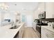 Modern kitchen features a large island, stainless steel appliances, and bright white cabinetry at 5550 Sabal Dr, St Cloud, FL 34771