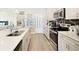 A modern kitchen offers stainless steel appliances and white countertops at 5550 Sabal Dr, St Cloud, FL 34771