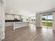 Open floor plan merges a modern kitchen with a breakfast nook and sliding glass doors to an outdoor patio at 5550 Sabal Dr, St Cloud, FL 34771