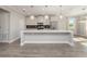 Spacious kitchen with white cabinetry, stainless steel appliances, large island, and wood floors at 5550 Sabal Dr, St Cloud, FL 34771