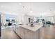 Open-concept kitchen with a large island, breakfast bar, and seamless flow into the dining and living areas at 5550 Sabal Dr, St Cloud, FL 34771
