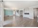 Expansive living area featuring luxury vinyl plank flooring, stylish wall decor, and a convenient wet bar at 5550 Sabal Dr, St Cloud, FL 34771