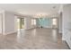 Large, bright living room features wood floors, statement wall and access to covered patio at 5550 Sabal Dr, St Cloud, FL 34771
