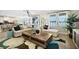 A sun-filled living room is furnished with white furniture and decorative throw pillows at 5550 Sabal Dr, St Cloud, FL 34771