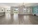 A bright living room is illuminated by a chandelier hanging from the ceiling at 5550 Sabal Dr, St Cloud, FL 34771