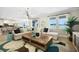 Inviting living room features a cozy sectional sofa, contemporary light fixture, and scenic views of the lake at 5550 Sabal Dr, St Cloud, FL 34771