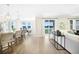 Open-concept living space featuring a kitchen, dining area, and access to the backyard at 5550 Sabal Dr, St Cloud, FL 34771