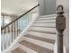 A staircase with wooden treads and white risers connects the main floor to the upper level of the home at 5550 Sabal Dr, St Cloud, FL 34771