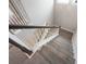 A staircase with wood stairs and white railing leads down to a carpeted landing at 5550 Sabal Dr, St Cloud, FL 34771
