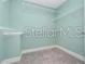 Bright walk-in closet with white shelving and light carpet offers ample storage space at 5550 Sabal Dr, St Cloud, FL 34771