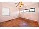 Simple bedroom with parquet flooring, natural light, and a ceiling fan at 5604 Astoria Pl, Orlando, FL 32808