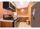 Modern kitchen featuring stainless steel appliances, a microwave, and a tiled floor at 5604 Astoria Pl, Orlando, FL 32808