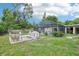A large backyard with a screened pool, patio, and green grass at 618 Acapulca Way, Altamonte Springs, FL 32714