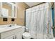 Cozy bathroom featuring a classic white vanity and a floral shower curtain at 618 Acapulca Way, Altamonte Springs, FL 32714