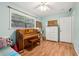 Bedroom features a piano, a bright window, and a white storage unit at 618 Acapulca Way, Altamonte Springs, FL 32714