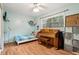 Bedroom includes piano, storage cubes, and bed beneath a bright window at 618 Acapulca Way, Altamonte Springs, FL 32714