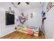 bedroom with hardwood floors, a TV, and a net full of stuffed animals at 618 Acapulca Way, Altamonte Springs, FL 32714