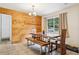 The dining room has wood-paneled walls and is furnished with a table and chairs at 618 Acapulca Way, Altamonte Springs, FL 32714