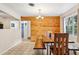 Bright dining room featuring wood paneled wall and natural light at 618 Acapulca Way, Altamonte Springs, FL 32714