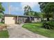 Front exterior of home with a covered screened porch and a long driveway at 618 Acapulca Way, Altamonte Springs, FL 32714