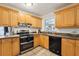 Spacious kitchen featuring wood cabinets and stainless-steel appliances at 618 Acapulca Way, Altamonte Springs, FL 32714