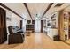Open living room featuring ceiling beams, custom cabinets, and a hardwood floor at 618 Acapulca Way, Altamonte Springs, FL 32714