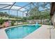 A screened pool with hot tub is surrounded by a concrete patio and a green fenced in backyard at 618 Acapulca Way, Altamonte Springs, FL 32714