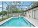 A screened pool with spa in a screened enclosure, overlooking the backyard at 618 Acapulca Way, Altamonte Springs, FL 32714