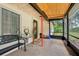 View of a screened porch featuring a wood ceiling, door, and seating to enjoy the outdoors at 618 Acapulca Way, Altamonte Springs, FL 32714