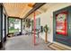 View of the screened porch with a wood ceiling, front door, seating, and a wall-mounted bike rack at 618 Acapulca Way, Altamonte Springs, FL 32714