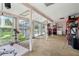 Sun room with view to the pool, equipped with seating, storage shelves, and a ceiling fan at 618 Acapulca Way, Altamonte Springs, FL 32714