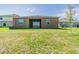 Expansive backyard featuring a well-maintained lawn, covered patio and mature tree at 716 Daring Dr, Davenport, FL 33837