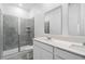 A bathroom provides double sinks, white cabinetry, a tiled shower, and tile flooring at 716 Daring Dr, Davenport, FL 33837