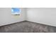 Carpeted bedroom features a window and natural light at 716 Daring Dr, Davenport, FL 33837