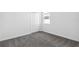 Carpeted bedroom includes a double door closet and small window at 716 Daring Dr, Davenport, FL 33837
