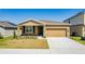 Charming single-story home with a well-maintained lawn and a two-car garage at 716 Daring Dr, Davenport, FL 33837