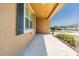 Exterior of home features a walkway to the front porch with decorative shutters and a tan facade at 716 Daring Dr, Davenport, FL 33837