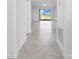 Bright hallway with tile flooring leading to a sliding glass door and tranquil water view at 716 Daring Dr, Davenport, FL 33837