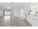 Open-concept living area with tile floors, sliding glass doors, and kitchen bar at 716 Daring Dr, Davenport, FL 33837