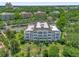 Beautifully landscaped condo community with lush greenery, palm trees, and a well-maintained building at 7613 Cabana Ct # 102, Reunion, FL 34747