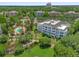 Aerial view of complex featuring lush greenery, a swimming pool, and well-maintained buildings at 7613 Cabana Ct # 102, Reunion, FL 34747