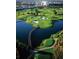 Picturesque aerial view of the community golf course, featuring a bridge and lush green fairways at 7613 Cabana Ct # 102, Reunion, FL 34747