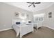 Inviting bedroom featuring twin beds, a ceiling fan, and a bright window at 7613 Cabana Ct # 102, Reunion, FL 34747