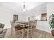 Bright dining area with a rustic table, wooden chairs, and light wood floors at 7613 Cabana Ct # 102, Reunion, FL 34747