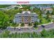 Condo building with mature trees and a view of the community's waterpark amenity at 7613 Cabana Ct # 102, Reunion, FL 34747