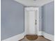 Close-up of the entry door with a light blue painted wall and a decorative white door frame at 7613 Cabana Ct # 102, Reunion, FL 34747