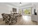 Bright living room with wood floors and sliding glass doors leading to an outdoor patio at 7613 Cabana Ct # 102, Reunion, FL 34747