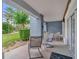 Covered patio with outdoor seating, offering a relaxing space and serene views at 7613 Cabana Ct # 102, Reunion, FL 34747