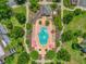 Aerial view of community pool surrounded by lush landscaping and lounge chairs at 7613 Cabana Ct # 102, Reunion, FL 34747